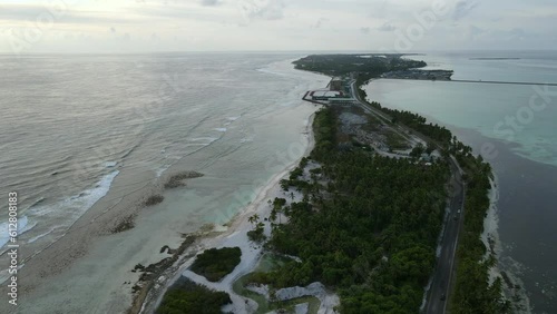 Aerial view of tropical beach landscape and local road at addu city, the southernmost atoll of Maldives in Indian ocean. Maldives tourism and summer vacation concepts. 4K footage drone video photo