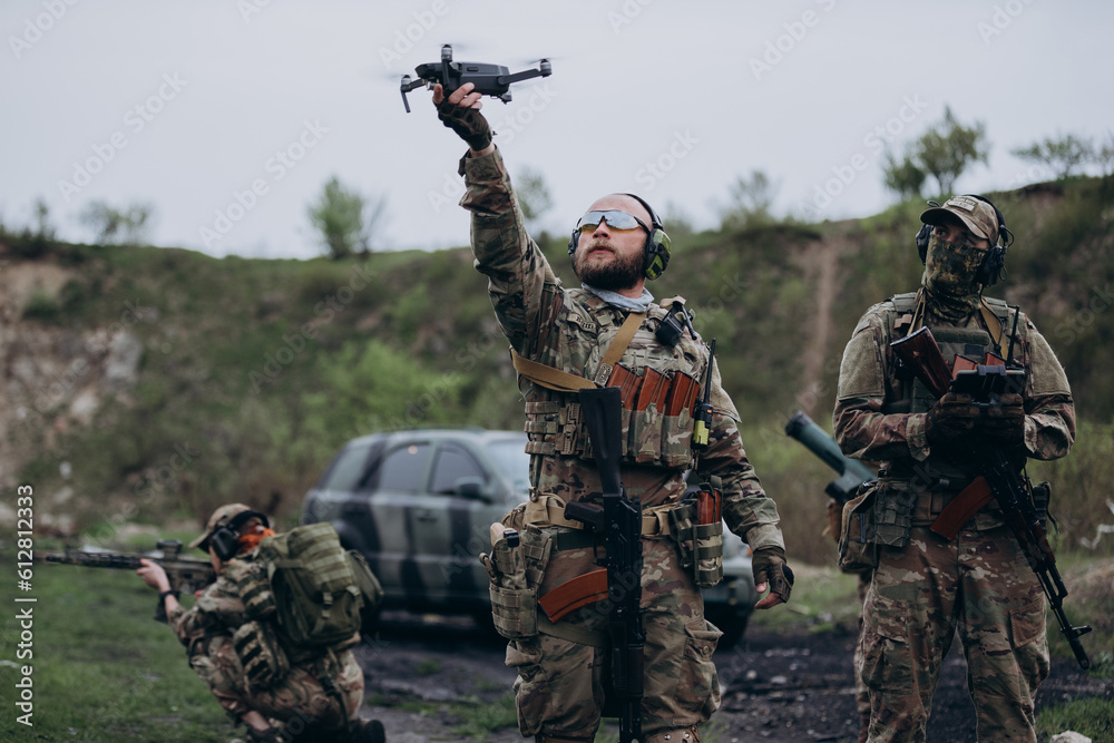 Group of Ukrainian soldiers using a drone at the range