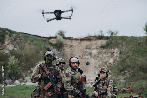 Armed Ukrainian militarymen using a drone