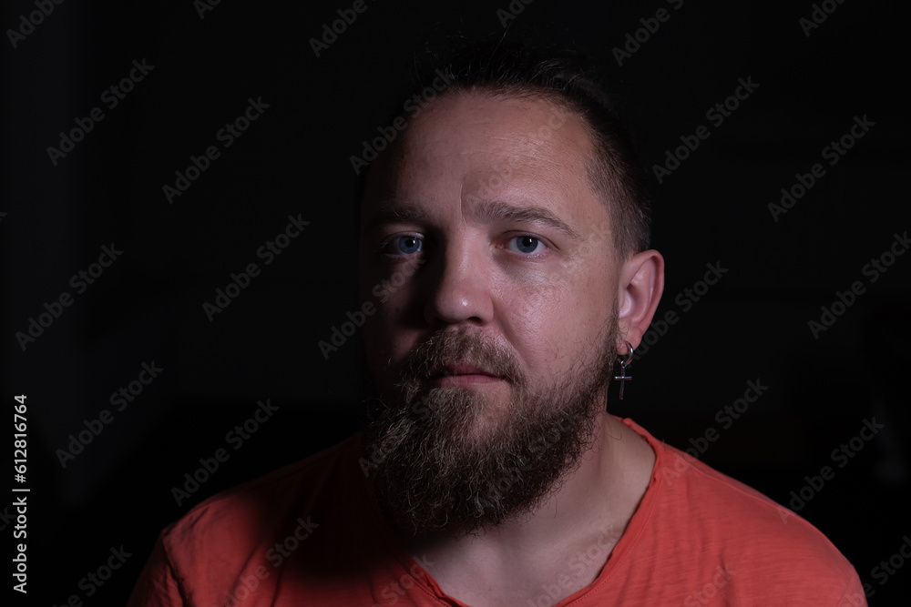 Dramatic low key portrait of a bearded man in a studio Dramatic low key portrait of a bearded man in a studio
