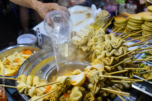 Hand adding water in bouillion for Korean fish cakes