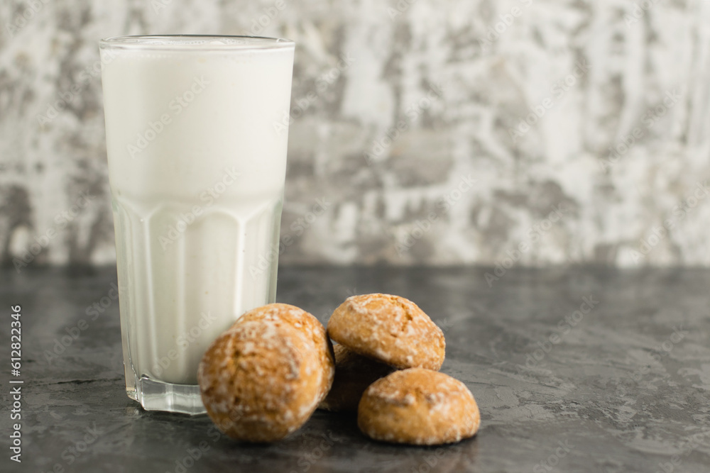 A delicious, refreshing summer drink, a milkshake made of milk and ice cream. Gingerbread on a dark table A delicious, refreshing summer drink, a milkshake made of milk and ice cream. Gingerbread on a dark table