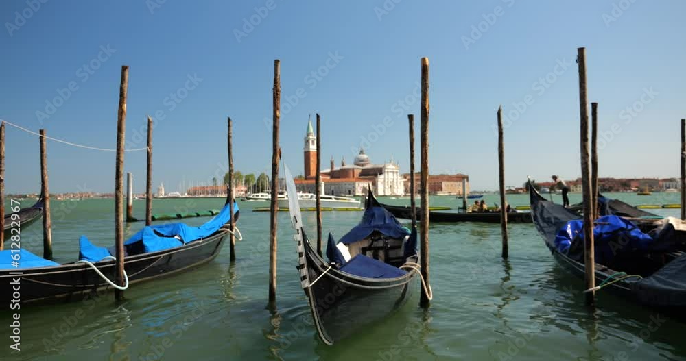 Gondolas moored with palines at the waterfront at the Riva degli Schiavoni, in Venice, Italy. Gondolas moored with palines at the waterfront at the Riva degli Schiavoni, in Venice, Italy.