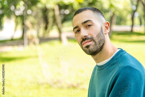 Young bearded man captivated in a natural park
