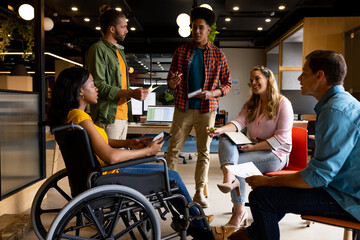 Diverse male and female colleagues in discussion in casual office meeting