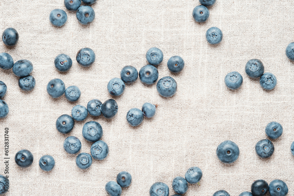 Fresh blueberries scattered on a linen napkin. Fresh blueberries scattered on a linen napkin.