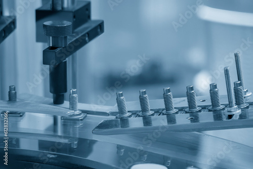 Photography The quality control process of metal screw production line.