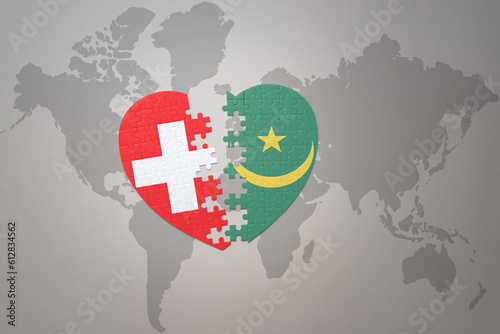 puzzle heart with the national flag of mauritania and switzerland on a world map background.Concept.