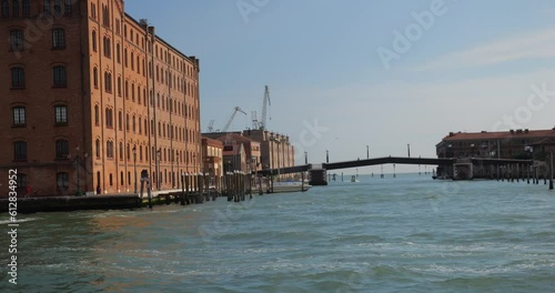 View from the ship board, bridge over the canal, bricoles and paline in Venetian Lagoon, Italy. Venice, Italy. photo