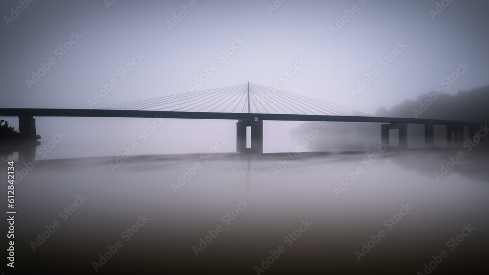 Fototapeta premium Two parallel bridges over foggy river. Long exposure shot. - generative ai