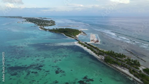 Aerial view of tropical beach landscape and local road at addu city, the southernmost atoll of Maldives in Indian ocean. Maldives tourism and summer vacation concepts. 4K footage drone video photo