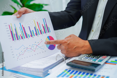Businessman working and analysis with statistic graph in office.