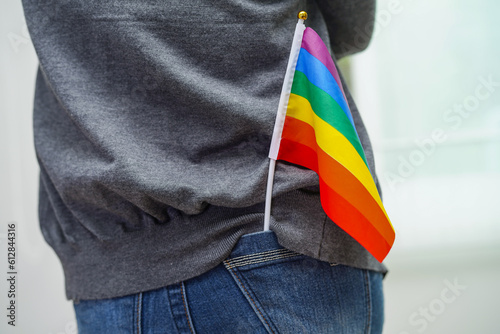Asian woman with rainbow flag, LGBT symbol rights and gender equality, LGBT Pride Month in June.