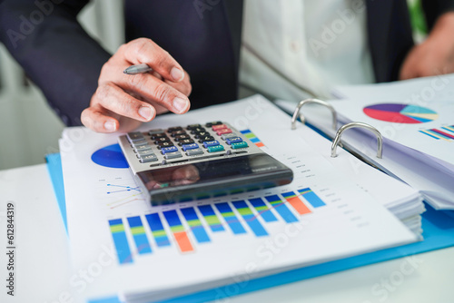 Businessman working and analysis with statistic graph in office.