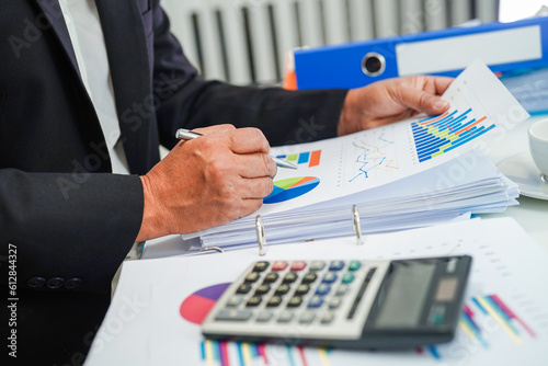 Businessman working and analysis with statistic graph in office.