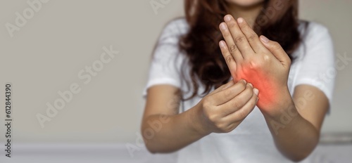 Asian woman scratching hand. Itchy skin diseases such as scabies, fungal infection, rash, etc.