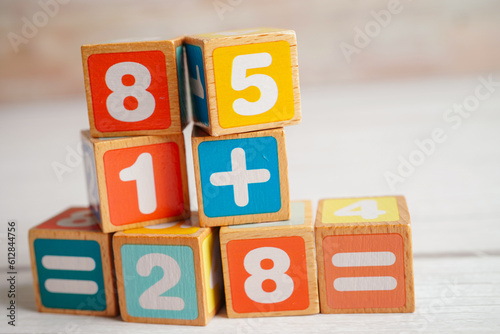 Number wood block cubes for learning Mathematic, education math concept.