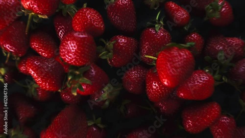 Strawberry background is jumping. Fresh juicy strawberries bouncing. Slow motion close up