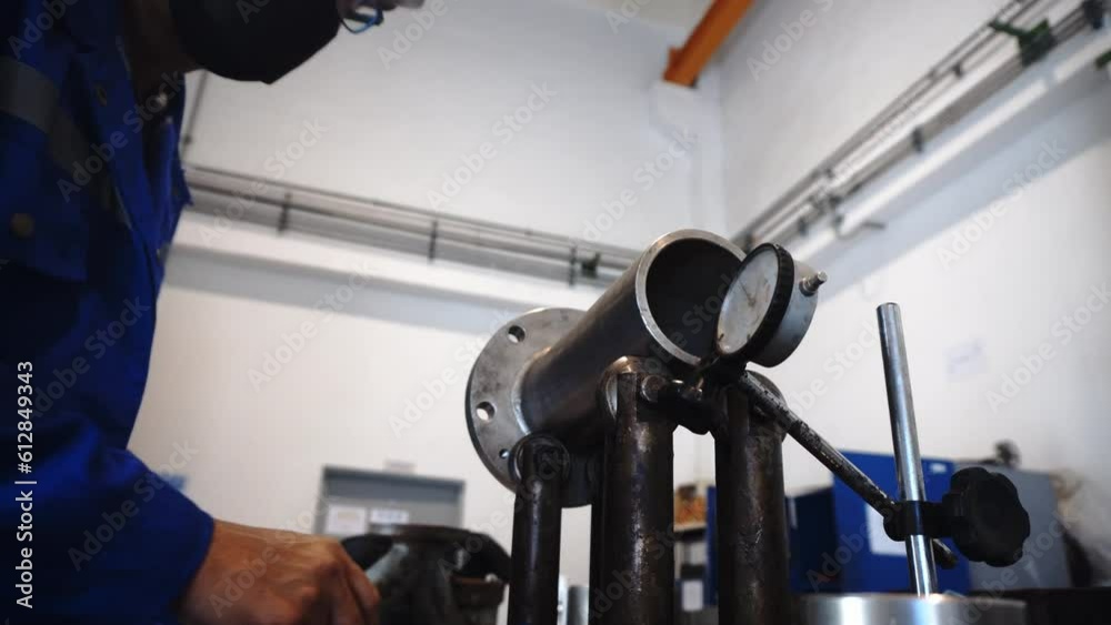 An engineer is measuring the accuracy of a pipe using a high precision distance gauge. safety, Industrial and engineering concepts. Working safely by wearing personal protective equipment. 4K Video An engineer is measuring the accuracy of a pipe using a high precision distance gauge. safety, Industrial and engineering concepts. Working safely by wearing personal protective equipment. 4K Video