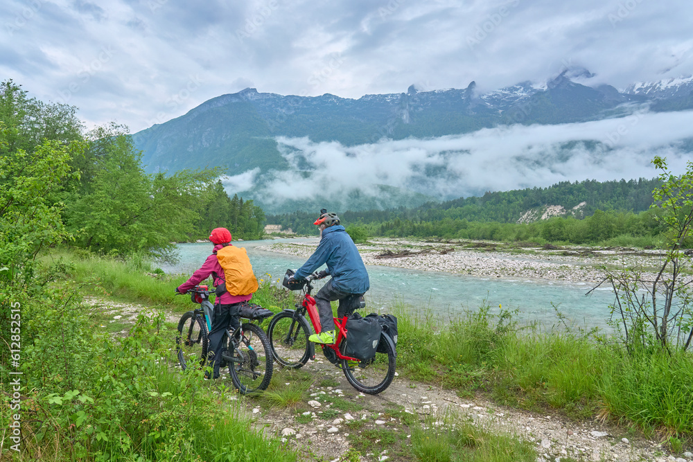 Obraz premium active senior couple on a e-bike tour in the Valley of River Soca, Triglav National Park near Bovec, Slovenia
