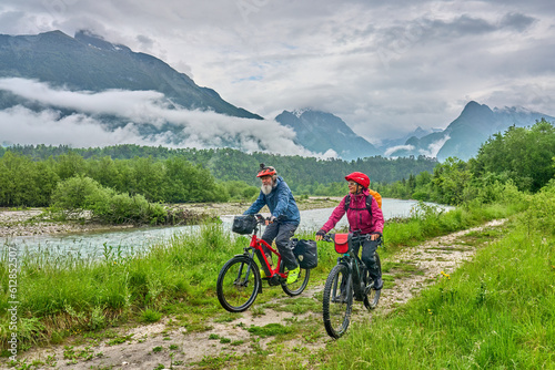 active senior couple on a e-bike tour in the Valley of River Soca, Triglav National Park near Bovec, Slovenia