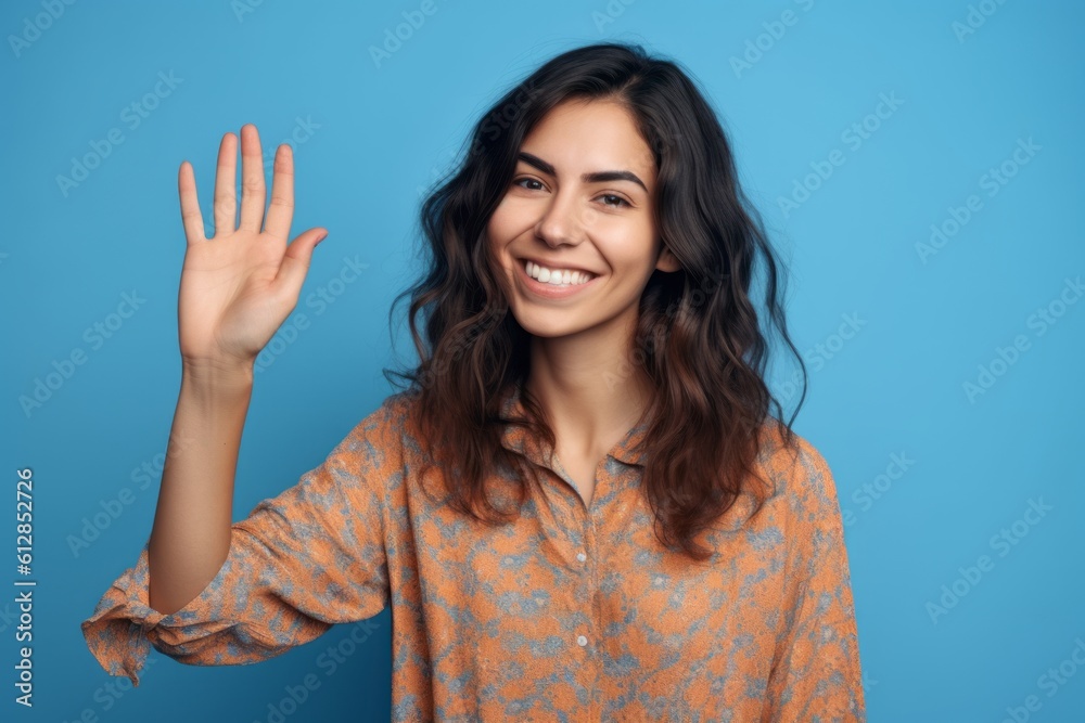 Close-up portrait photography of a joyful girl in her 30s making a no or stop gesture with the extended palm against a periwinkle blue background. With generative AI technology Close-up portrait photography of a joyful girl in her 30s making a no or stop gesture with the extended palm against a periwinkle blue background. With generative AI technology
