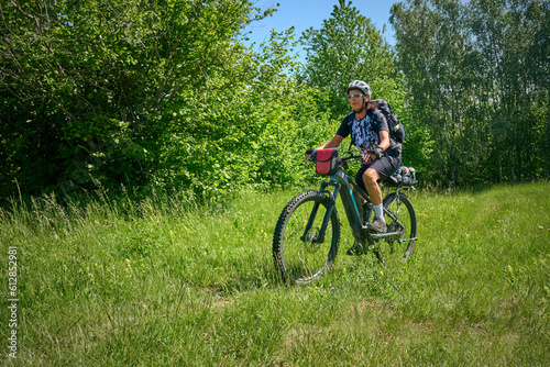 nice active senior woman on a bike tour with their electric mountain bikes in the Karst Mountains of Slovenia near Solkan