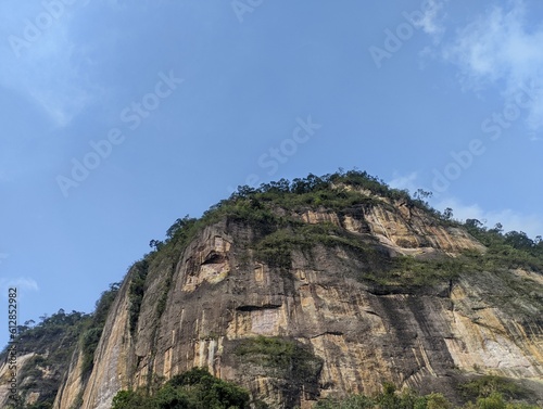 rock hill with grass ( Bangluru) isolated on sky background. the name of this hill is the Indonesian harau hill photo
