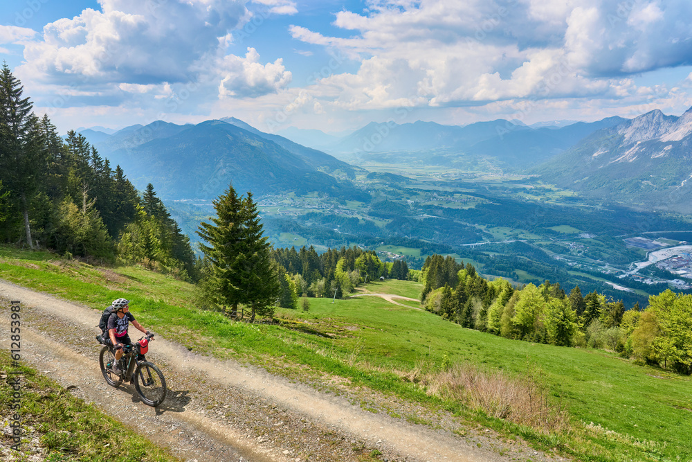 active senior woman on a mountain bike tour in the carinthian alps above Villach in Austria