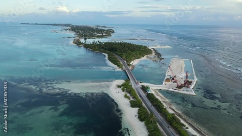 Aerial view of tropical beach landscape and local road at addu city, the southernmost atoll of Maldives in Indian ocean. Maldives tourism and summer vacation concepts. 4K footage drone video photo