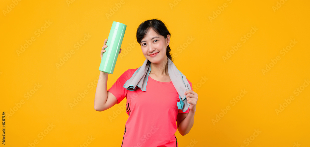 Portrait young asian sports fitness woman happy smile wearing pink sportswear and smartphone doing exercise training workout against yellow studio background. technology wellness lifestyle concept. Portrait young asian sports fitness woman happy smile wearing pink sportswear and smartphone doing exercise training workout against yellow studio background. technology wellness lifestyle concept.