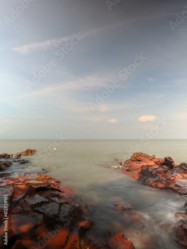 panoramic view of a red rock beach on sunny day