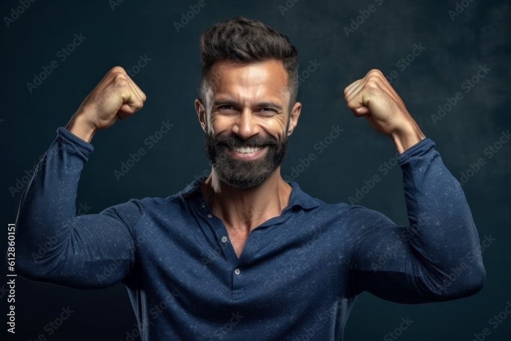 Medium shot portrait photography of a glad boy in his 30s making a i'm strong gesture showing muscles against a deep indigo background. With generative AI technology