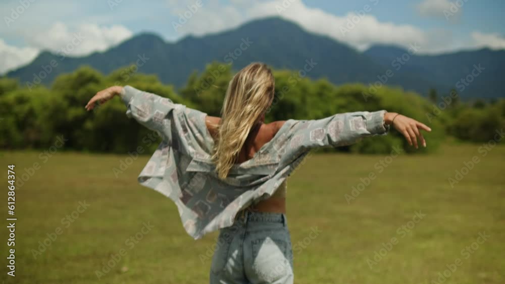 Tourist Woman at the mountains, freedom. Happy girl relaxing and doing yoga on the field with mountain view. Tourist Woman at the mountains, freedom. Happy girl relaxing and doing yoga on the field with mountain view.