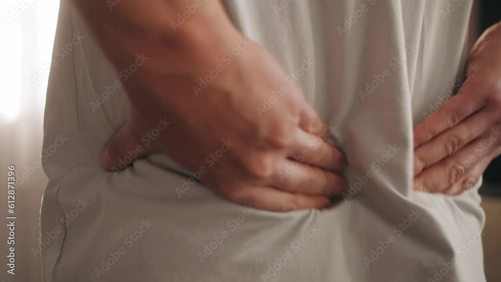 Back pain, close up young man has injury during outdoor exercise, pain after work at home. Back pain, close up young man has injury during outdoor exercise, pain after work at home.