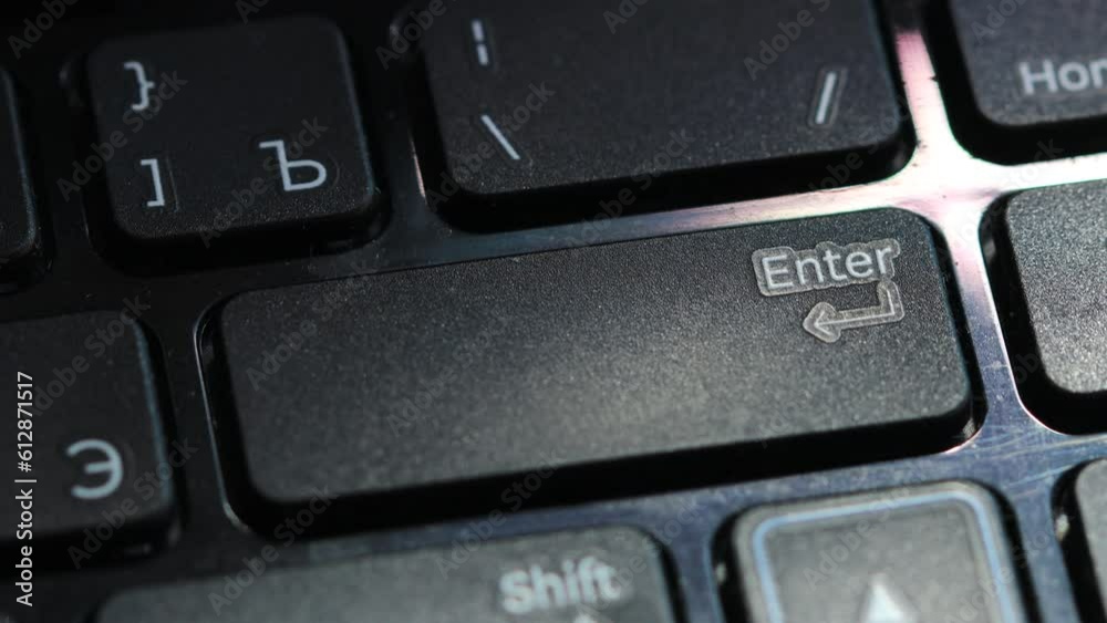 finger presses enter button on laptop keyboard. finger presses enter button on laptop keyboard.