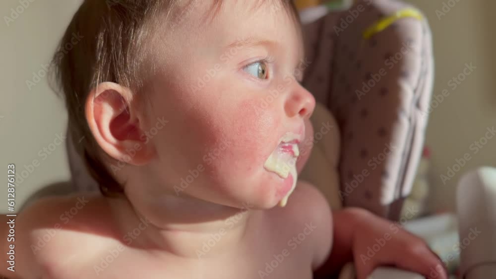 dirty baby eats. baby a girl eating yogurt milk food close-up stained her mouth face. happy family healthy baby food concept. little baby girl lifestyle learning to eat her mouth stained with yogurt dirty baby eats. baby a girl eating yogurt milk food close-up stained her mouth face. happy family healthy baby food concept. little baby girl lifestyle learning to eat her mouth stained with yogurt