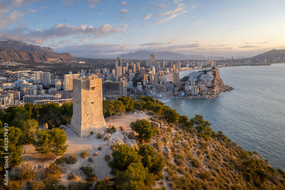 Naklejka premium Aerial view of Torre d'Aguiló with Benidorm (Alicante, Spain) in the background.