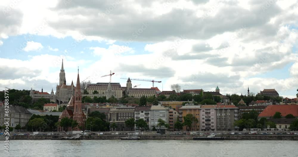 West bank of the Danube river, Fisherman's Bastion and blue sky with white clouds in sunny spring day in Budapest, Hungary. West bank of the Danube river, Fisherman's Bastion and blue sky with white clouds in sunny spring day in Budapest, Hungary.