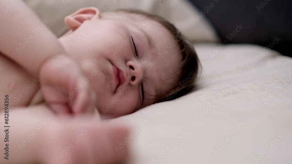 Cute chubby baby sleeping on soft bed with white sheet after breastfeeding innocent little boy with closed eyes taking nap in cozy nursery at home closeup Cute chubby baby sleeping on soft bed with white sheet after breastfeeding innocent little boy with closed eyes taking nap in cozy nursery at home closeup