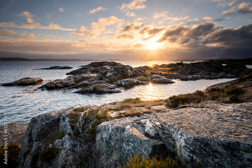 sunshine at sunset on rocky beach in summer sunshine at sunset on rocky beach in summer