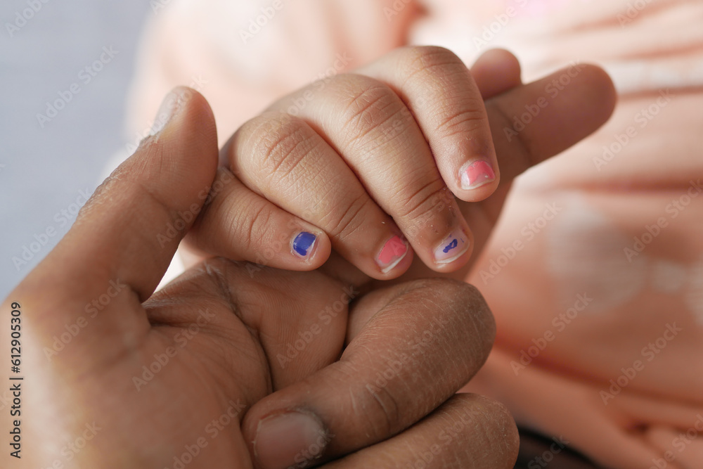 father holding hand of baby child, close up . father holding hand of baby child, close up .