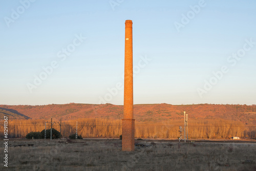 Antique Industrial Brick Chimney from 1947 next to the train tracks