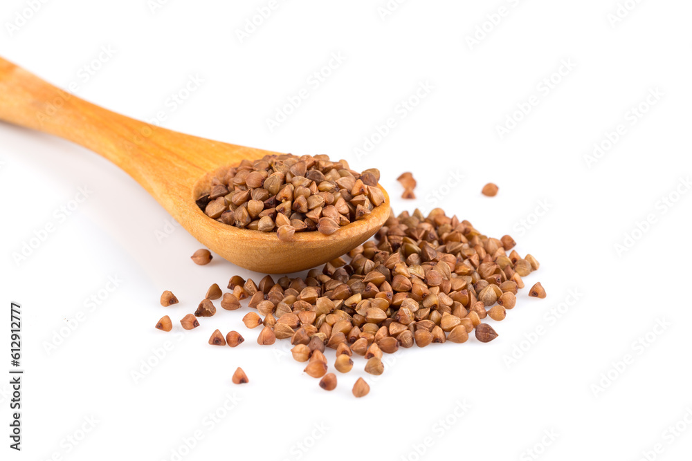 Uncooked buckwheat on wooden spoon Uncooked buckwheat on wooden spoon