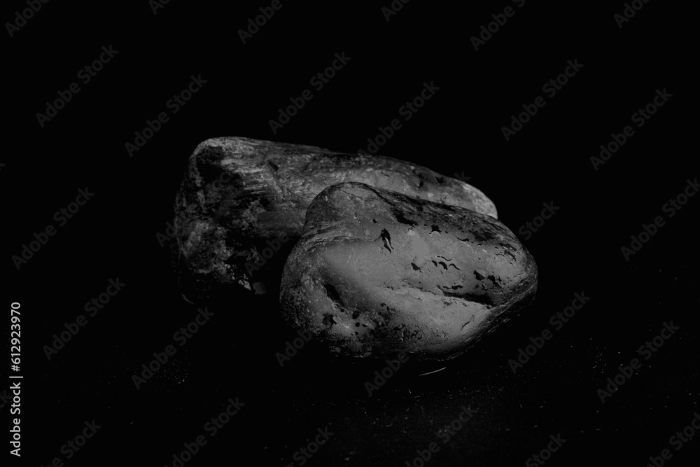 Black stone with water drops on black background for products. Concept scene for promotion, sale, presentation or cosmetics Black stone with water drops on black background for products. Concept scene for promotion, sale, presentation or cosmetics