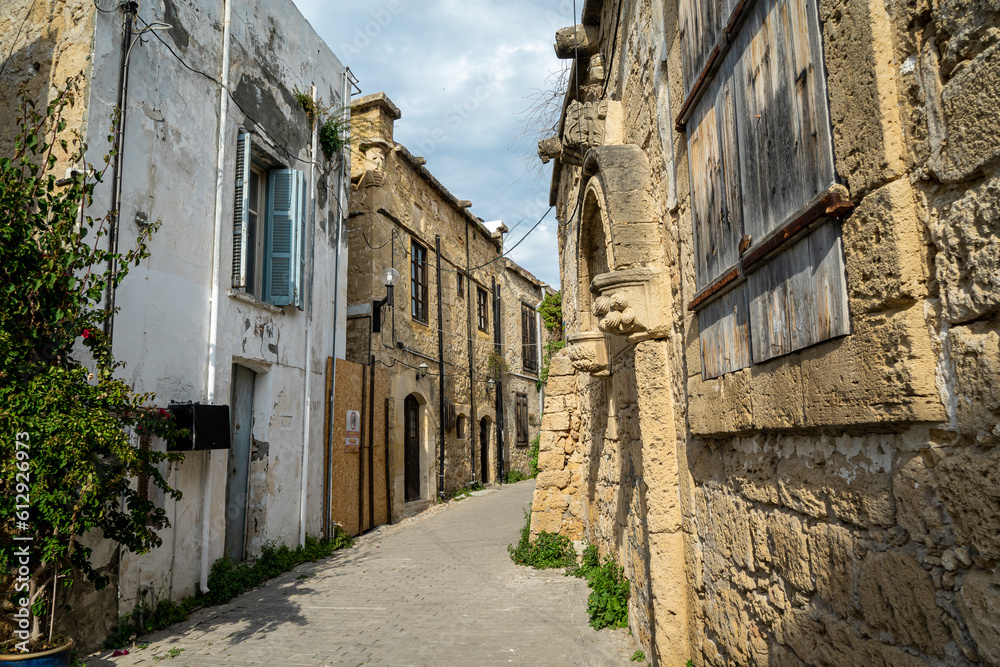 A street by traditional Kyrenia stone houses in the old town. Old city street view in Kyrenia or Girne, Northern Cyprus.