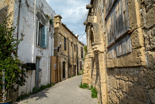 Fototapeta Naklejka Na Ścianę i Meble -  A street by traditional Kyrenia stone houses in the old town. Old city street view in Kyrenia or Girne, Northern Cyprus.
