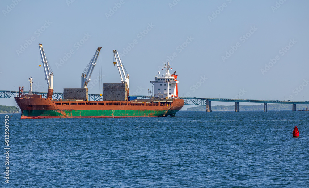 Newport, Rhode Island. A Cargo Ship and Newport Bridge viewed from Fort Adams State Park. Newport, Rhode Island. A Cargo Ship and Newport Bridge viewed from Fort Adams State Park.