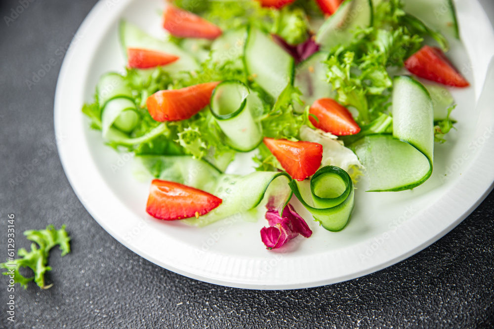fresh salad strawberry cucumber, lettuce diet meal food snack on the table copy space food background rustic top view 