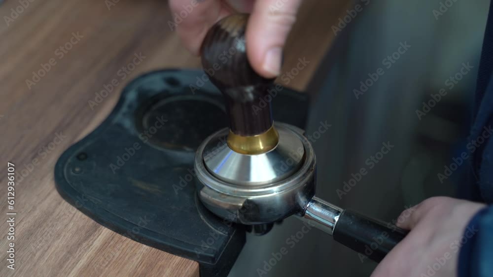 Barista grinding fresh coffee beans for a flavorful cup Barista grinding fresh coffee beans for a flavorful cup